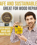 No Drama Wood Filler Powder For Straight Shooting Grain Repair And Total Game Changing White Oak Tintable Mix With Water To Crush Shrinking And Cracking 150 Gram Pack held by smiling man in a renovated kitchen.