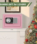 Pink Mini Safe Box With Code And Keys, 0.236 Cubic Feet, displayed on a mantel beside a decorated Christmas tree.