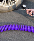 Using Purple Polyurethane Recoil Air Hose For Air Compressors One Quarter Inch Inner Diameter By Twenty Five Feet to inflate a tire