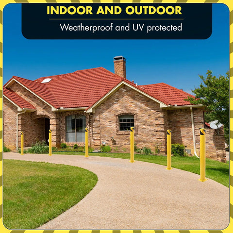Two yellow Hella Sturdy Removable Steel Bollards Surface Mounted Parking Barrier 2 Pack installed along a driveway.