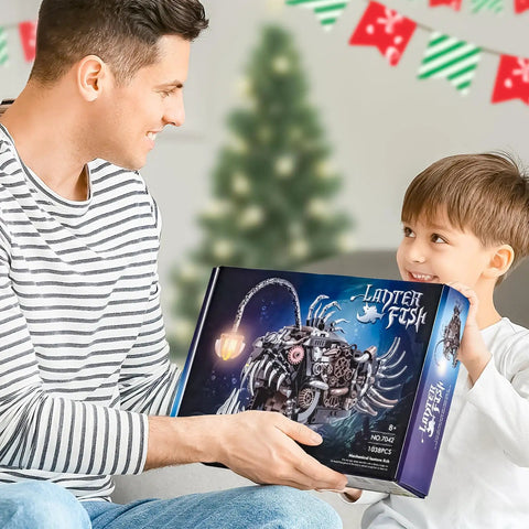 Lit Lantern Fish Mechanical Building Set With 1038 Pieces STEM Construction Toy For Adults And Teens Realistic Deep Sea Model That Doubles As A Glow Lamp Hours Of Creative Play And Display. box held by man and child