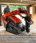 Mini excavator with hydraulic breaker attachment in a garage setting