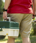 Person carrying 3-Tray Tackle Box With Dual Top Access Dark Green Metallic And Off White Premium Tackle Storage for anglers.