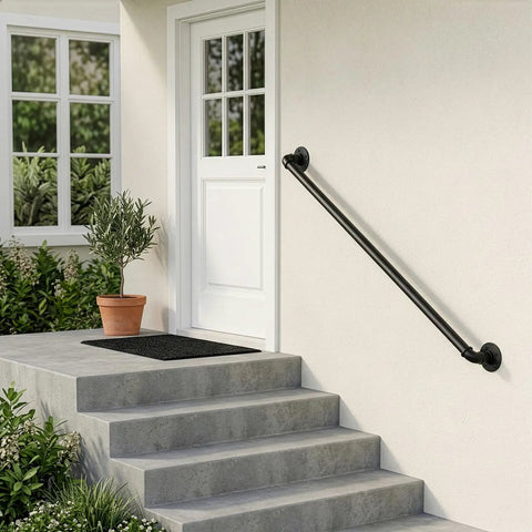 Heavy Duty Four Foot Iron Stair Handrail In Matte Black Finish Rust Resistant Body For Indoor Or Outdoor Staircases With Dead Simple Hardware Setup For Quick Weekend Fixes installed on steps leading to a white door.