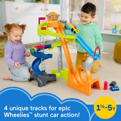 Toddlers playing with Hot Wheels Spiral Stunt Speedway Race Track Playset with loop and jump features.