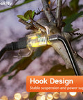 Beefy Workhorse 50 Foot Heavy Duty Outdoor Extension Cord Waterproof with Lighted End hanging on a tree branch showcasing hook design