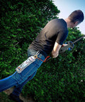 Man using Weatherproof Extension Cord Protector With Clear Housing Hook And Security Loop Fits Standard And Heavy Duty Cords Up To 12 Gauge.