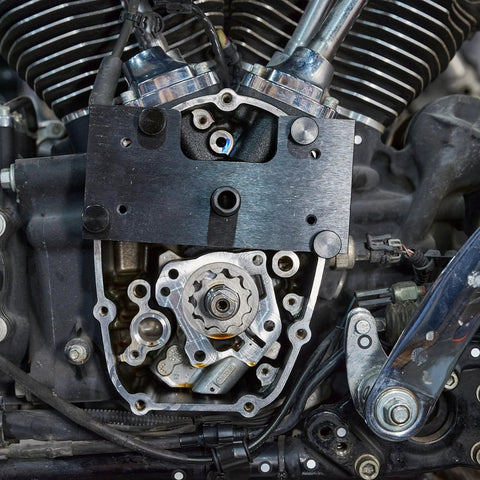 Installed view of Mofun inner camshaft bearing installer on Harley M8 engine; black rectangular tool over timing gear area.