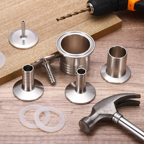 Top Shelf Pro Grade One Point Five Inch Tri Clamp To Quarter Inch Hose Barb Adapter Connector Solid SUS304 Stainless Steel on wooden surface.