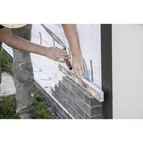 Mason working with London Brick Trowel With DuraSoft Handle For Pro Masonry Projects Thirteen By Five Point Three Eight Inch Forged High Carbon Steel Made In USA Great For Block Work Stonework And Bricklaying