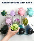 Hand accessing bottle in Three Tier Stackable Water Bottle Organizer With Large Compartments, Clear PET Bottle Holder For Cabinets