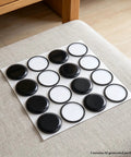 16 Pack Furniture Sliders 1.5 Inch Black Heavy Duty Glide Mats For Carpet And Hardwood Floors on a light fabric surface.