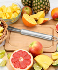 V Shaped Stainless Steel Pineapple Eye Cutter And Remover Tool For Home Kitchen on cutting board with assorted fruits