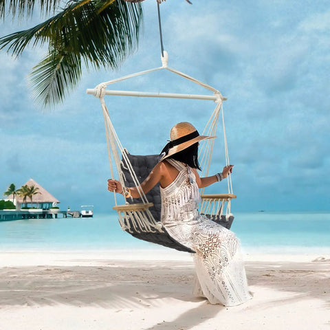 Person sitting on a Chill Indoor Outdoor Hammock Chair With Wooden Armrests, Steel Spreader Bar And Anti Slip Rings, on a beach