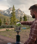 Camping scene with Portable Propane Stove With 10,000 BTU Burner Chrome Anti-Clog Design On Off Regulator Seven Point Five Inch Cooking Grid