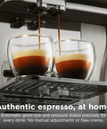 Fully Automatic Espresso Machine With 10 Custom Options And Built In Grinder Pours Barista Level Coffee into double glass cups.