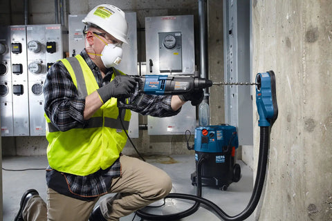 Worker using Two Cutter Head Three Quarter Inch By Twenty Four Inch SDS Plus Bulldog Rotary Hammer Bit for drilling concrete wall.