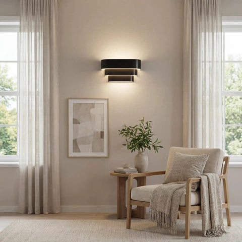One Light Louvered Wall Sconce Light Fixture In Black Finish, Modern Design For Entryway Hallway Foyer Bedroom And Living Room, Tri Band Louvered Shade That Glows From The Top, Seven Inch Tall wall mounted above a chair in living room