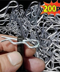 Close-up of 200 pcs R Shaped Cotter Pins Stainless Steel Hairpin Clips Assortment Kit with hand holding one pin.