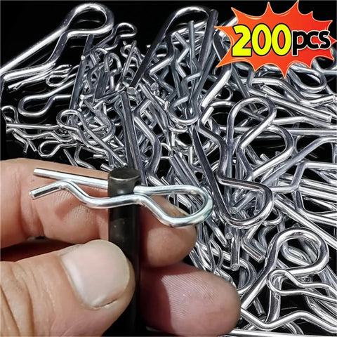 Close-up of 200 pcs R Shaped Cotter Pins Stainless Steel Hairpin Clips Assortment Kit with hand holding one pin.
