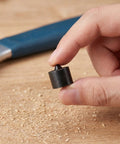 Heavy Duty Metal Shaft End Protectors For Grip-O-Matic Pullers shown being held, black metal cap for machine spindle stability.