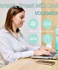 Portable 22oz Stainless Steel Breast Milk Cooler Bottle Keeps Pumped Stash Ice Cold For Up To Twenty Four Hours Goes Hard For Moms On The Go All Day Long with a woman working at a laptop.
