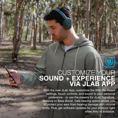 Man wearing JBuds Lux ANC Over Ear Headphones With Wireless Active Noise Cancellation outdoors using smartphone app