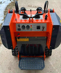 Rear view of Compact 460 Mini Skid Steer Loader showing controls for front loader and hydraulic grapple bucket attachments