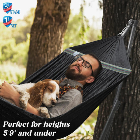 Man relaxing with dog in Uniki Hammock Stand With 3 Year Warranty Instant 30 Second Foldable Hammock Setup 550 Lb Capacity For One Person Grab And Go Portable Durable Outdoor Indoor Use Black Perfect For Camping Backyard Patio And Cozy Lounging