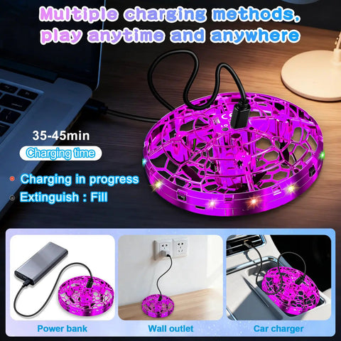 Image of a purple Kids UFO Drone With Hand Gesture Control And LED Lights Indoor Outdoor Hover Boomerang on a charging cable.