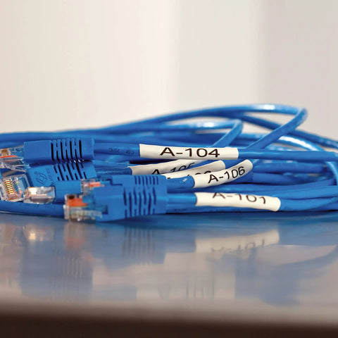 Heavy Duty Industrial Heat Shrink Label Rolls, 1/4 Inch Tube With Black Print On White labels on blue network cables.