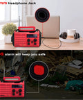 NOAA Weather Radio With Battery Backup And Solar Hand Crank on table, showing headphone jack and SOS alarm feature
