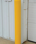 Slide On Yellow Bollard Post Cover For Warehouses Made From Durable Low Density Polyethylene Thermoplastic, installed outdoors.