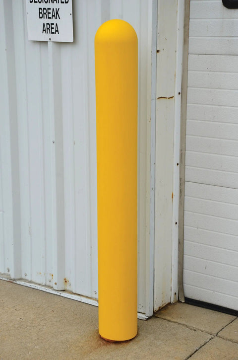 Slide On Yellow Bollard Post Cover For Warehouses Made From Durable Low Density Polyethylene Thermoplastic, installed outdoors.