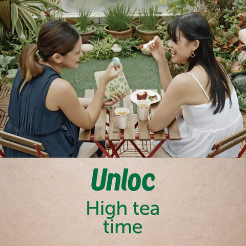 Two women enjoying snacks using eco-friendly paper sandwich bags at an outdoor cafe, showcasing Earth Friendly Paper Sandwich And Snack Bags Pack Of 50 Recyclable Non Wax Paper With Sealable Closures And Fun Earthy Brown Designs For Lunches And Snacks For Grab And Go.