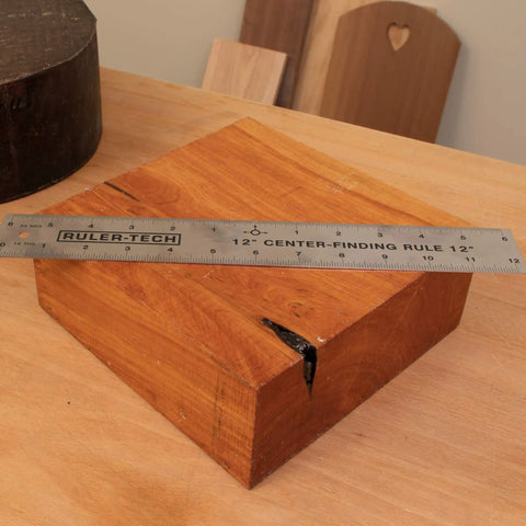 Stainless Steel Center Finder Ruler With No Guesswork And Dual Scale, 12 inch, on a wooden block for precise center marking