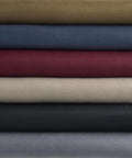 Six rolls of automotive headliner fabric with foam backing in beige, blue, burgundy, olive, charcoal, gray.