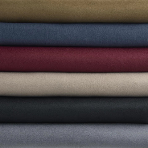 Six rolls of automotive headliner fabric with foam backing in beige, blue, burgundy, olive, charcoal, gray.