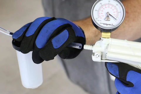 Heavy Duty Hand Vacuum Pump Brake Bleeder Kit With Gearless Diaphragm Gauge in use, showing gloves and integrated gauge.