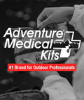 Hands holding Ultralight Watertight Medical Kit.9 from Adventure Medical Kits, outdoors.
