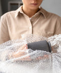 Person using Bubble Cushioning Roll, 72 Ft Long, 12 Inch Wide, Three Sixteenth Inch Air Bubbles, Perforated Every 12 Inches, Easy Tear.