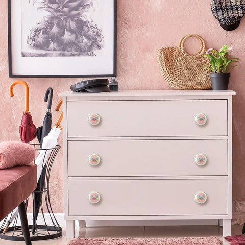Multicolor Butterfly Ceramic Cabinet Pulls Set With Gold Accent Knobs on dresser in room decor
