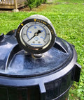 MEASUREMAN pool filter pressure gauge on black pool filter lid, 2-inch dial, 0–60 psi, bottom mount