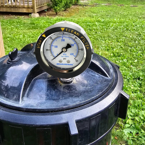 MEASUREMAN pool filter pressure gauge on black pool filter lid, 2-inch dial, 0–60 psi, bottom mount
