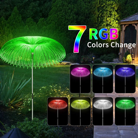 Solar Jellyfish Garden Lights 6 Pack Waterproof Outdoor Pathway Lawn Decor With 7 Color Changing Optical Fiber Bodies, Easy Setup Yard Lights For Parties Weddings Festivals glowing in a garden at night.