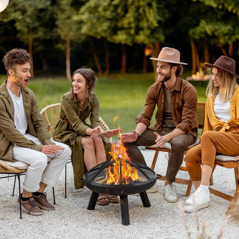 Group enjoying fire pit with 36 Inch Round Fire Pit Screen With Handle And Poker, Collapsible Heavy Duty Mesh Cover, outdoors.