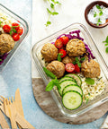 10 Pack 22 Oz Glass Meal Prep Containers With Airtight Locking Lids For Portion Control, Microwave Oven Freezer And Dishwasher Safe, BPA Free, Stackable Lunch Storage For Work, At The Gym, On The Go Leftovers Grey, filled with meatballs, cherry tomatoes, cucumber slices, rice, and fresh herbs