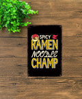 Ramen Obsessed Vintage Metal Tin Sign Wall Art 8x12 Inch for kitchen decor with text 'Spicy Ramen Noodle Champ' on wood background.