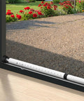 Heavy Duty Adjustable Sliding Door Security Bar Built Tough To Hold Your Ground With Cushioned Rubber Feet For Foolproof Window And Patio Door Blocking Setup White against a garden.
