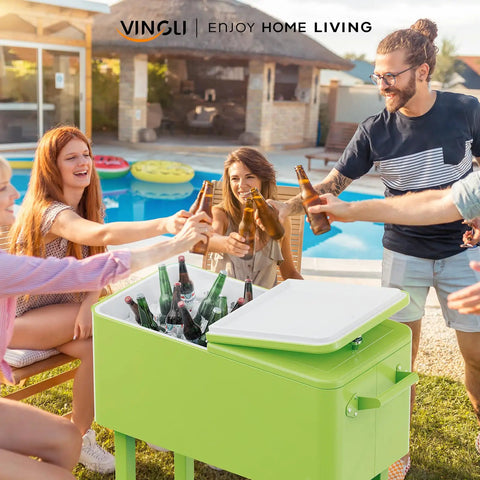 80 Quart Rolling Ice Chest Cooler Cart For Patio Parties And Party Ready Backyard Bar Setup With Folding Shelf And Bottle Opener Light Green Portable Beverage Cooler On Wheels with people enjoying drinks by a poolside.
